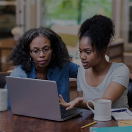 Image of mother and daughter working on a laptop